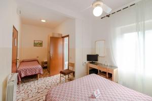 Postel nebo postele na pokoji v ubytování Villa Rosy