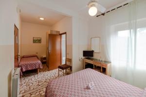 Postel nebo postele na pokoji v ubytování Villa Rosy