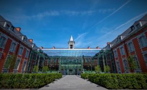a large building with a clock tower in the distance at Royal Hainaut Spa & Resort Hotel in Valenciennes