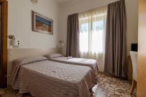 Postel nebo postele na pokoji v ubytování Villa Rosy