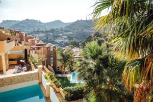 a view from the balcony of a hotel with palm trees at Cotobro Rental House in Almuñécar