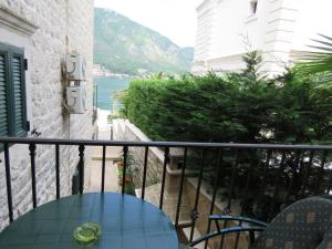 a balcony with a table and a view of the ocean at Apartmani Jasmina in Kotor