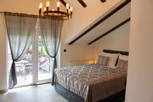 a bedroom with a bed and a large window at Villa Waterfalls Plitvice in Rakovica