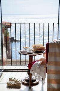 a table on a balcony with a view of the ocean at I Bastioni San Domenico - Boutique Hotel in Gallipoli