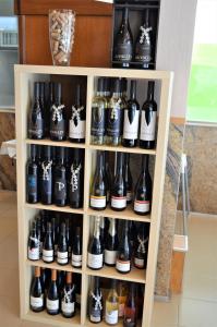a shelf filled with lots of bottles of beer at Hotel Santa Catarina Algarve in Portimão