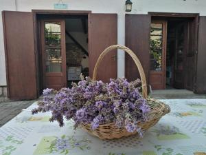 a basket of purple flowers sitting on a table at Sobe Gajić in Sremski Karlovci
