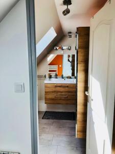 a bathroom with a sink and a mirror at Maison de ville à Albert in Albert