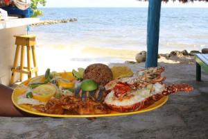a plate of food with seafood on the beach at Hotel Puntanorte in Tintipan Island