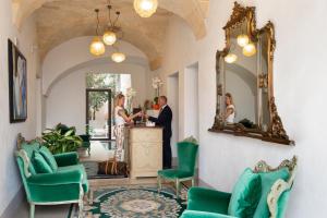 a room with a table, chairs, and a large mirror at I Bastioni San Domenico in Gallipoli