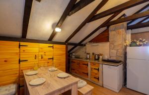cocina con mesa de madera y nevera blanca en Apartments Villa ViDa Orebić en Orebić