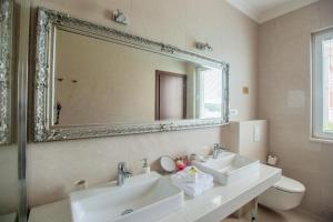 a bathroom with two sinks and a large mirror at Stone House Buljanovic in Sali +88 photos