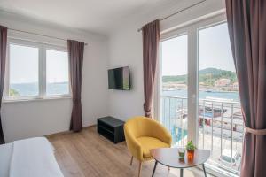 a hotel room with a bed and a large window at Stone House Buljanovic in Sali