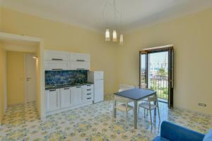 a kitchen with a table and a dining room at Casa Vacanze Don Mimì in Acciaroli