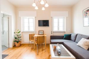 a living room with a couch and a table at Torrinha House in Lagos