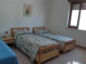 Postel nebo postele na pokoji v ubytování Baia Unci