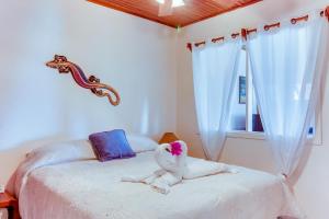 a stuffed animal laying on a bed in a bedroom at Flamingo Marina Resort in Playa Flamingo