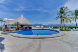 a swimming pool at a resort with palm trees at Flamingo Marina Resort in Playa Flamingo