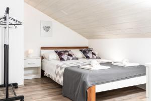 a bedroom with a bed with two towels on it at Apartment Adriana in Vela Luka