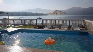 a swimming pool with an orange ball in the water at Casa Yuppy Du in Eşelniţa +12 photos