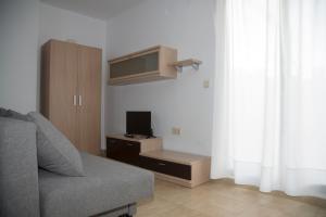 ein Wohnzimmer mit einem Sofa und einem TV in der Unterkunft Apartamento con vistas al mar en Torre de la Horadada in Pilar de la Horadada