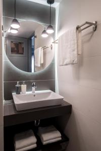 a bathroom with a sink and a mirror and towels at apt.27-102 in Nafplio