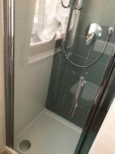 a shower stall with a glass door and a shower at Casetta Rosada in Malo +7 photos
