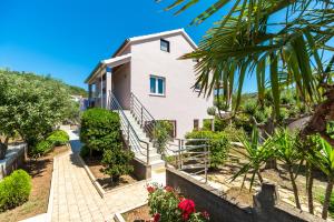 a villa with a staircase leading up to a house at Apartment Adriana in Vela Luka