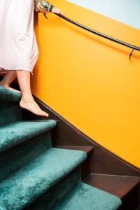 a woman standing on a stairway next to stairs at Hotel Bruno in Middelburg