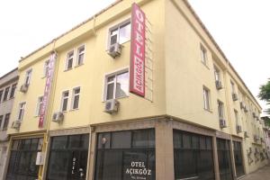 a yellow building with signs on the side of it at Acikgoz Hotel in Edirne