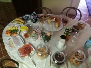 a table with a white table cloth with food on it at B&B La Casa di Rita in Porto San Giorgio
