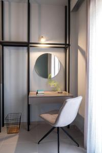 a desk with a chair and a mirror at apt.27-102 in Nafplio +28 photos