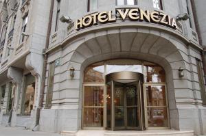 a store front of a building with a sign on it at Hotel Venezia by Zeus International in Bucharest