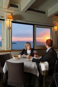 a man and woman sitting at a table with wine glasses at I Bastioni San Domenico - Boutique Hotel in Gallipoli