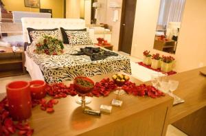 a bedroom with a bed with flowers on a table at Victor Plaza Formiga in Formiga