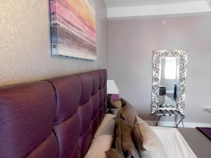 a bedroom with a bed and a mirror at The Gould Hotel in Seneca Falls