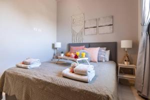 a bedroom with a bed with towels and fruit on it at Magical 3BR/Parking with amazing view, city center in Jerusalem
