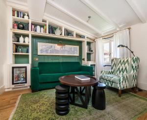 a living room with a green couch and a table at Hotel Cort in Palma de Mallorca