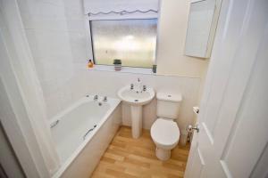 a white bathroom with a toilet and a sink at Henry's Guesthouse in Bath +43 photos