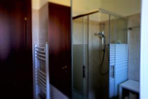 a bathroom with a shower and a glass door at Pezzelelle in Roccamorice +49 photos