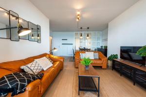 a living room with a couch and a television at Première ligne de plage, face à la mer in Hendaye