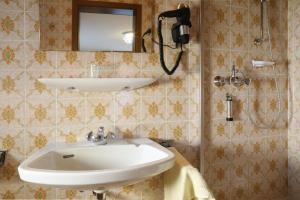 a bathroom with a sink and a shower at Bio & Vegi Pension Krennleiten in Schönau am Königssee