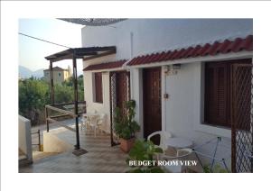 a balcony of a house with a table and chairs at Aeolos Hotel Apartments in Gythio