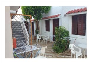 a patio with a table and chairs and a building at Aeolos Hotel Apartments in Gythio