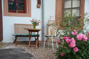 a table and two chairs and a table and flowers at Schloss Fischbach in Eisenach