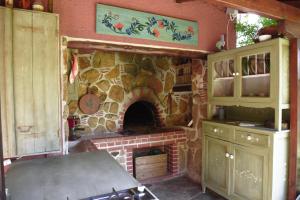 a kitchen with a stone fireplace in a room at Zacharoulas Katikies in Amarynthos