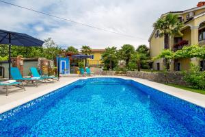a swimming pool in the backyard of a house at Apartment Patricia in Rijeka