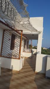 a porch of a building with chairs and a roof at Aeolos Hotel Apartments in Gythio