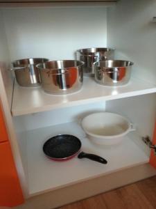 a shelf with pots and pans on it in a kitchen at Apartmán ALEX in Poprad