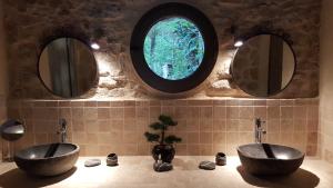 two sinks in a bathroom with two mirrors at Villa Eden Vert in Fayence