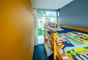 a bedroom with two bunk beds and a window at Dr House in Bitola +2 photos